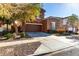 Two-story house with brown exterior, two-car garage, and landscaped front yard at 13627 N 150Th Ave, Surprise, AZ 85379