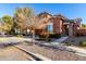 Two-story house with brown exterior, two-car garage, and landscaped front yard at 13627 N 150Th Ave, Surprise, AZ 85379