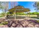 Wooden gazebo with a shaded seating area, perfect for relaxing at 13627 N 150Th Ave, Surprise, AZ 85379