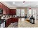 Kitchen with granite countertops, dark wood cabinets, and a view to backyard at 13627 N 150Th Ave, Surprise, AZ 85379