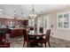 Kitchen with dark wood cabinets, island, and breakfast area at 13627 N 150Th Ave, Surprise, AZ 85379