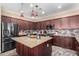 Modern kitchen featuring granite countertops, dark wood cabinetry, and stainless steel appliances at 13627 N 150Th Ave, Surprise, AZ 85379