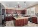 Spacious kitchen with granite island, stainless steel appliances, and dark wood cabinets at 13627 N 150Th Ave, Surprise, AZ 85379