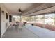 Covered patio with seating area and ceiling fan at 14702 W Buttonwood Dr, Sun City West, AZ 85375