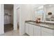 Bathroom with double vanity, granite countertops, white cabinetry, and a walk-in closet at 1649 N Fenway Dr, Florence, AZ 85132