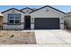 New single-story home with gray garage door and desert landscaping at 1649 N Fenway Dr, Florence, AZ 85132