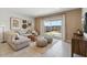 Cozy living room with a comfortable sofa, decorative pillows, and a sliding glass door to a patio at 1649 N Fenway Dr, Florence, AZ 85132