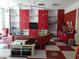 Bright playroom with red cabinets, a TV, and a curved sofa at 1649 N Fenway Dr, Florence, AZ 85132