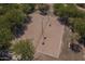 Aerial view of a sand volleyball court with lights and surrounded by lush greenery in this active community at 1649 N Fenway Dr, Florence, AZ 85132