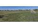 Expansive green community soccer field under a bright, clear blue sky with manicured grass and soccer goals in place at 1649 N Fenway Dr, Florence, AZ 85132