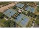 Aerial view of well-maintained tennis courts surrounded by lush landscaping at 1649 N Fenway Dr, Florence, AZ 85132