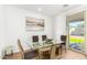 Dining area with glass table, four chairs, and access to backyard at 18443 W Villa Chula Ln, Surprise, AZ 85387