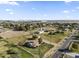 Aerial view of a ranch-style home with a large yard and surrounding neighborhood at 19320 W Melvin St, Buckeye, AZ 85326