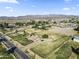 Aerial view of a house on acreage with mature trees and mountain backdrop at 19320 W Melvin St, Buckeye, AZ 85326