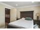 Cozy bedroom with dark wood furniture and adjacent closet at 19320 W Melvin St, Buckeye, AZ 85326