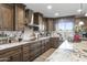 Modern kitchen features stainless steel appliances, granite countertops, and custom wood cabinetry at 19320 W Melvin St, Buckeye, AZ 85326