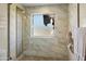 Clean shower with marble tile and window at 19320 W Melvin St, Buckeye, AZ 85326