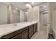 Modern bathroom with double vanity and tile floors at 19929 W Roma Ave, Litchfield Park, AZ 85340