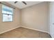 Well-lit bedroom featuring tile floors and a window at 19929 W Roma Ave, Litchfield Park, AZ 85340