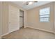 Bright bedroom with tile floors and a spacious closet at 19929 W Roma Ave, Litchfield Park, AZ 85340