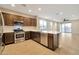 Open-concept kitchen featuring an island and stainless steel appliances at 19929 W Roma Ave, Litchfield Park, AZ 85340