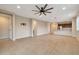 Spacious living room with tile floors and ceiling fan at 19929 W Roma Ave, Litchfield Park, AZ 85340