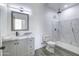 Modern bathroom with gray vanity and marble shower at 205 E Jackson Ave, Buckeye, AZ 85326