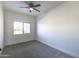 Simple bedroom with gray carpet and ceiling fan at 205 E Jackson Ave, Buckeye, AZ 85326