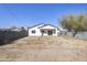 Back of house with a large yard and block wall at 205 E Jackson Ave, Buckeye, AZ 85326