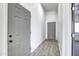 Interior hallway with gray doors and wood-look tile floor at 205 E Jackson Ave, Buckeye, AZ 85326