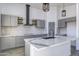 Modern kitchen with gray cabinets, quartz countertops, and a large island at 205 E Jackson Ave, Buckeye, AZ 85326