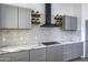 Modern kitchen with gray cabinets and quartz countertops at 205 E Jackson Ave, Buckeye, AZ 85326