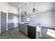 Modern kitchen with gray cabinets, quartz countertops and island at 205 E Jackson Ave, Buckeye, AZ 85326