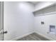 Laundry room with wood-look flooring and overhead shelving at 205 E Jackson Ave, Buckeye, AZ 85326