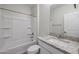 Well-lit bathroom featuring a granite vanity top, toilet, and a tub-shower combination at 24636 W Hopi St, Buckeye, AZ 85326