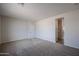 A well-lit bedroom offers neutral carpeting and paint, and an attached closet at 24636 W Hopi St, Buckeye, AZ 85326