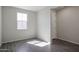 Bright bedroom with gray wood-look flooring and a window at 24636 W Hopi St, Buckeye, AZ 85326