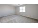 Bedroom with light colored carpet, white walls and a window providing natural light at 24636 W Hopi St, Buckeye, AZ 85326