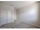 Empty bedroom with carpet, light walls and closet space at 24636 W Hopi St, Buckeye, AZ 85326