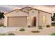 Single-story home with a two-car garage and desert landscaping at 24636 W Hopi St, Buckeye, AZ 85326