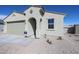 A single-story home featuring a two-car garage, neutral color scheme, and landscaping at 24636 W Hopi St, Buckeye, AZ 85326