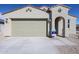 Single-story home showcasing a neutral color scheme, two-car garage, and a well-kept front yard at 24636 W Hopi St, Buckeye, AZ 85326