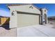 A two-car garage and a driveway is featured on this home's exterior at 24636 W Hopi St, Buckeye, AZ 85326