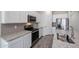 Granite counters accent this modern kitchen with stainless appliances at 24636 W Hopi St, Buckeye, AZ 85326