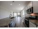 This open kitchen features white cabinets and granite counters at 24636 W Hopi St, Buckeye, AZ 85326