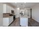 Bright and airy kitchen with white cabinets and an island at 24636 W Hopi St, Buckeye, AZ 85326