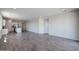 Expansive living room area featuring tile floors and seamless flow to the open kitchen at 24636 W Hopi St, Buckeye, AZ 85326