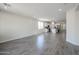 Spacious living area with gray wood-look tile flooring and a view into the kitchen space at 24636 W Hopi St, Buckeye, AZ 85326