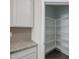 Walk-in pantry featuring built-in shelving and tile floor at 24636 W Hopi St, Buckeye, AZ 85326