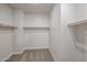 A walk-in closet offers ample storage space with carpet and shelving at 24636 W Hopi St, Buckeye, AZ 85326